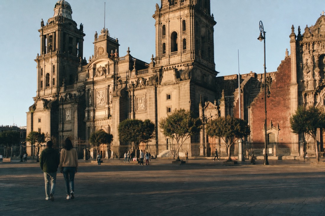 The long red facade of the Palacio Nacional along the east side of the Zócalo in Mexico City